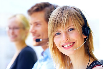 A friendly secretary/telephone operator in an office environment.